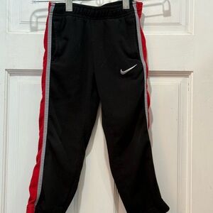 Nike Kids Black Joggers with Red Stripes